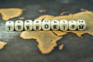 Wooden blocks with the text, TERRORISM, on the background of world map